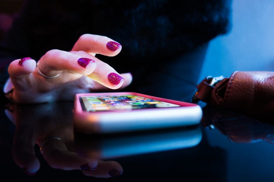 Fingers tapping a phone screen