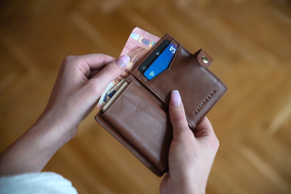 Hand pulling a card from a wallet